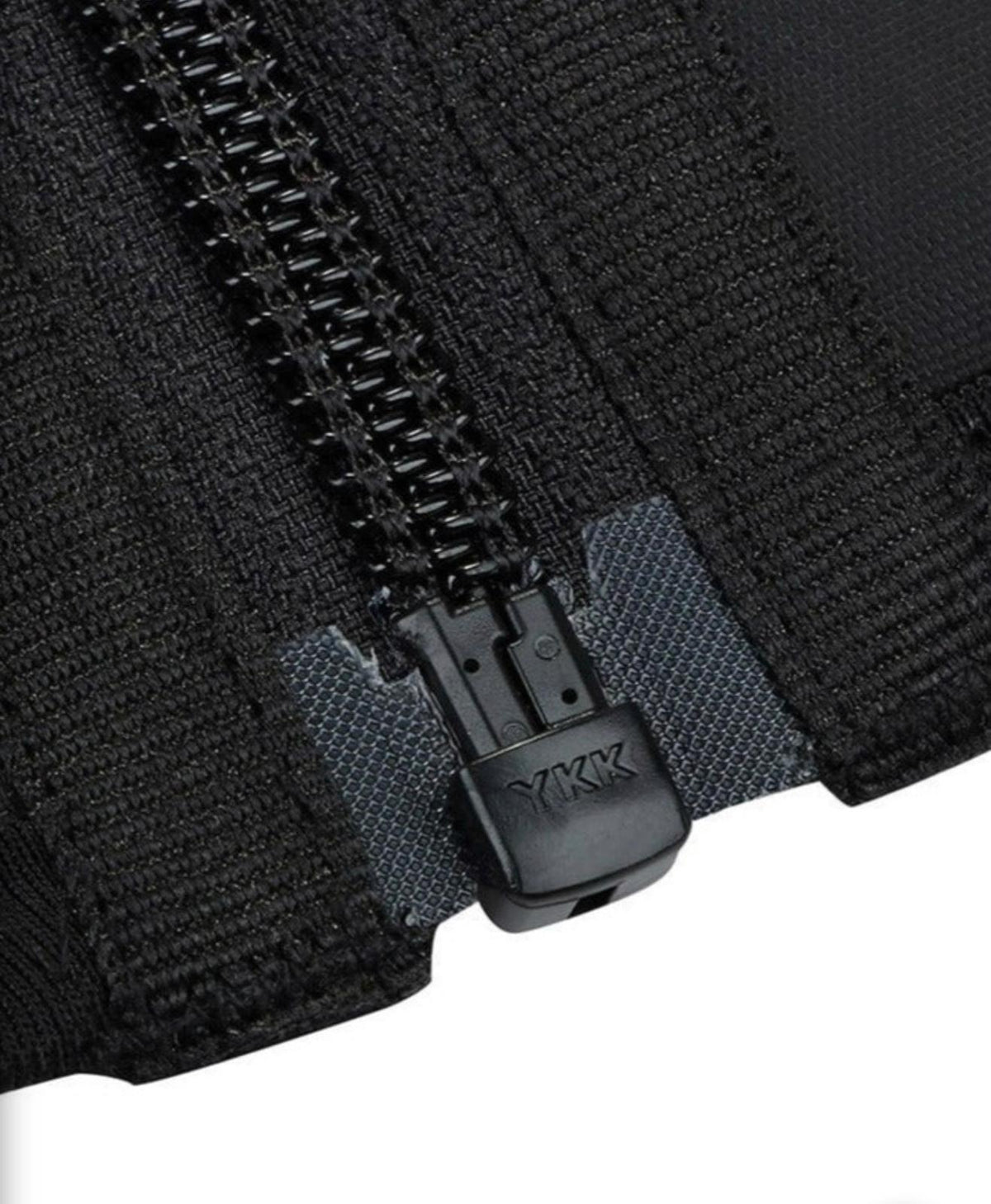 Close-up of YKK zipper on women's waist trainer sweat belt for secure tummy control closure